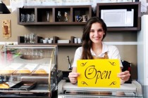 business woman holding open sign